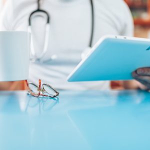 Doctor in his practice with a digital tablet